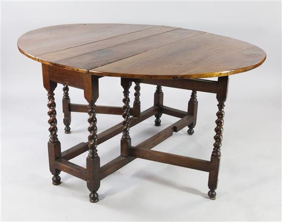 An 18th century walnut oval gateleg dining table, extended 4ft 9in.